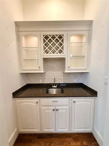 a kitchen with granite countertop a sink and a window