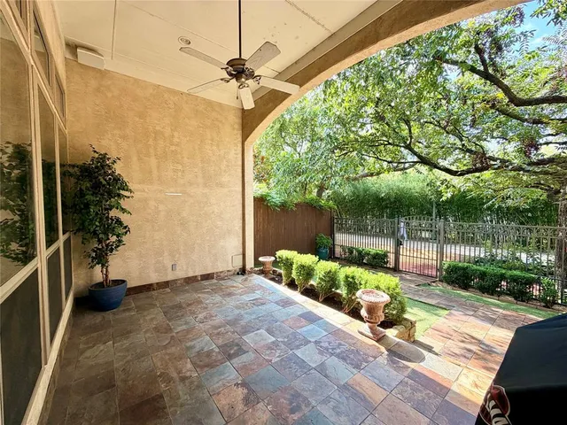 a view of a porch with furniture and garden