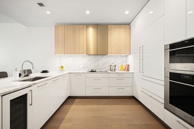 a kitchen with granite countertop stainless steel appliances and sink