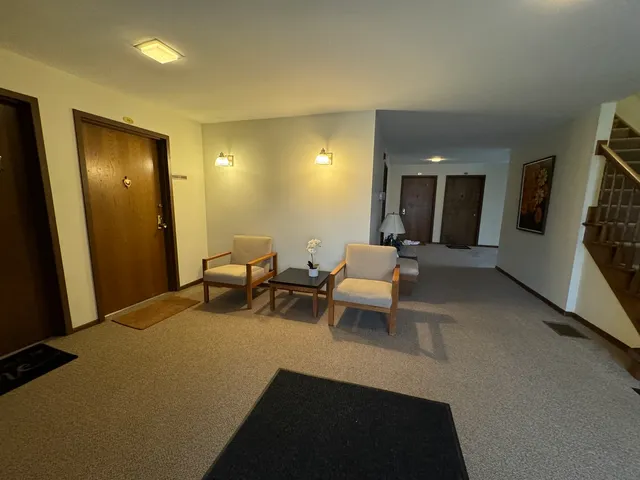 a living room with furniture and a mirror