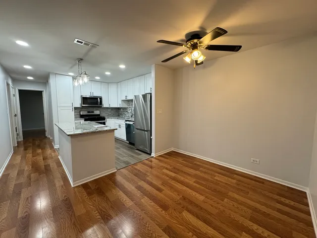 a view of kitchen with microwave and cabinets