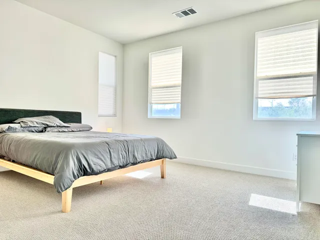 a bedroom with a bed and window