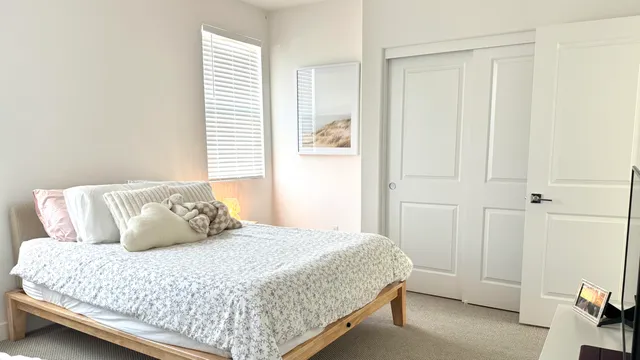 a bedroom with a bed and window