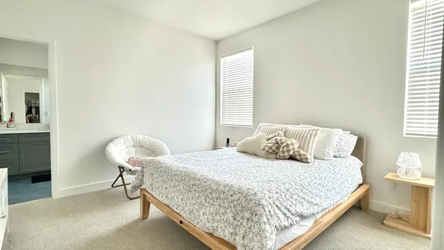 a bedroom with a bed and window