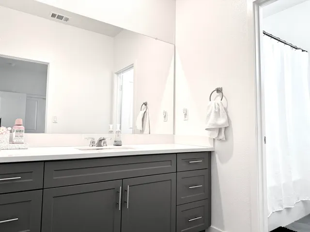 a bathroom with a sink double vanity and mirror