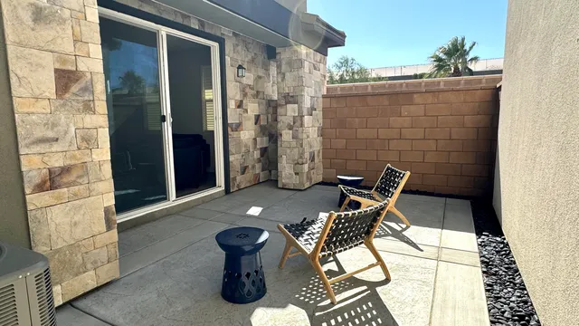 a view of a chairs and table in the balcony