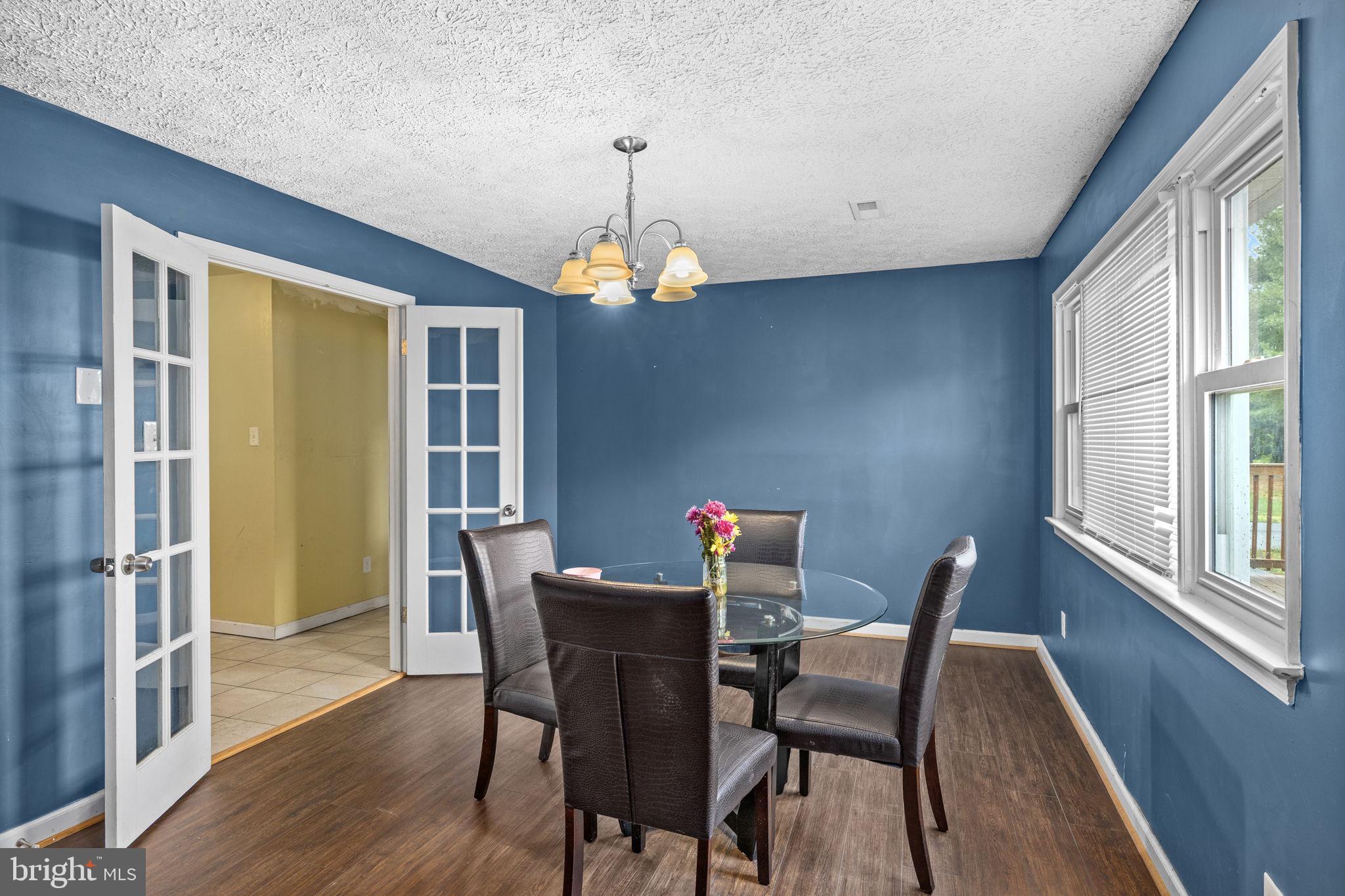 13245 Glen Level Drive Ruther Glen, VA 22546 - Photo 14 of 37 a dining room with furniture a chandelier and wooden floor