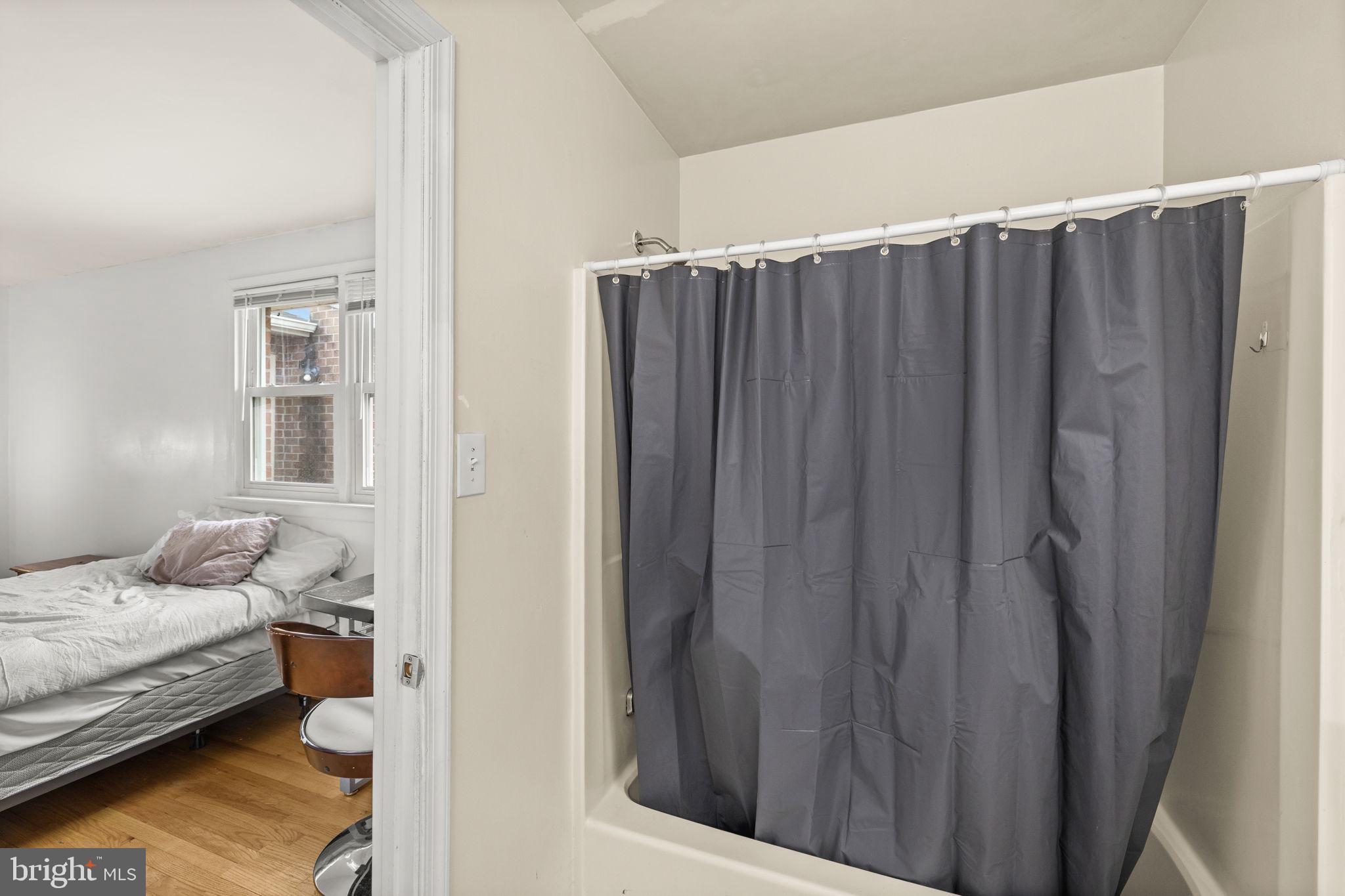 13245 Glen Level Drive Ruther Glen, VA 22546 - Photo 24 of 37 a bedroom with a bed and curtain