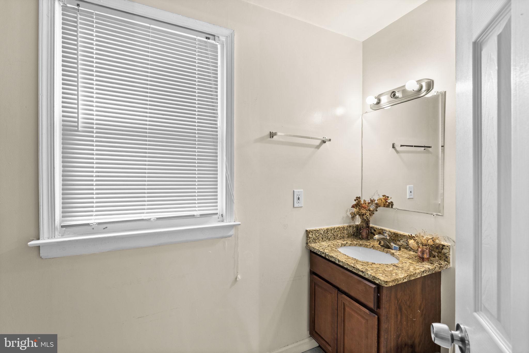 13245 Glen Level Drive Ruther Glen, VA 22546 - Photo 25 of 37 a bathroom with a granite countertop sink and a mirror