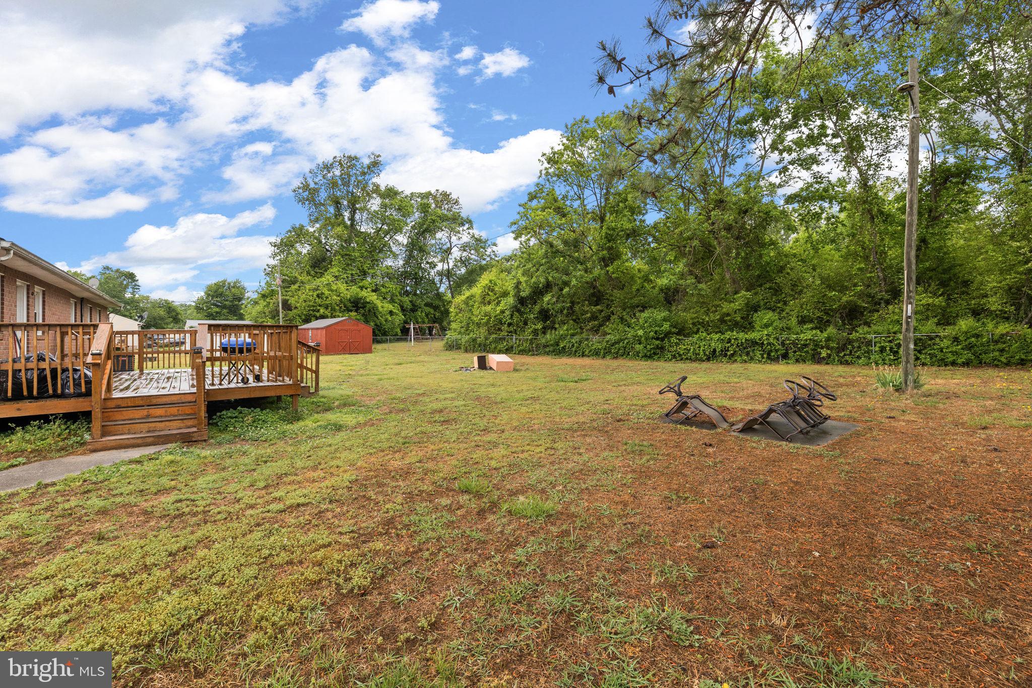 13245 Glen Level Drive Ruther Glen, VA 22546 - Photo 33 of 37 a view of yard with swimming pool and trees
