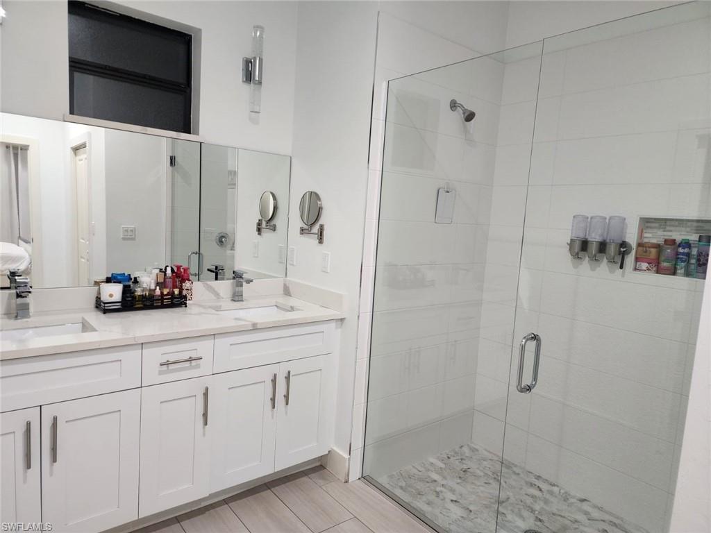 1720 46th Terrace Southwest Naples, FL 34116 - Photo 21 of 24 Bathroom featuring walk in shower and vanity