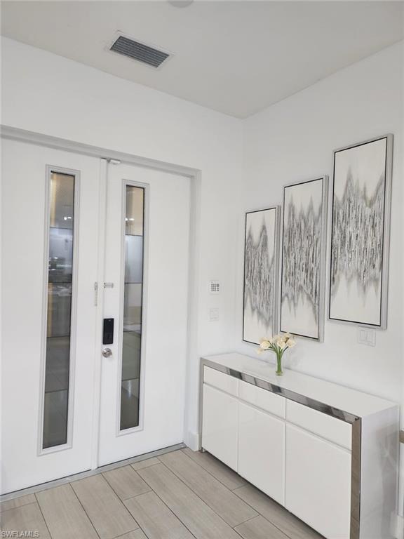 1720 46th Terrace Southwest Naples, FL 34116 - Photo 9 of 24 Hallway featuring french doors