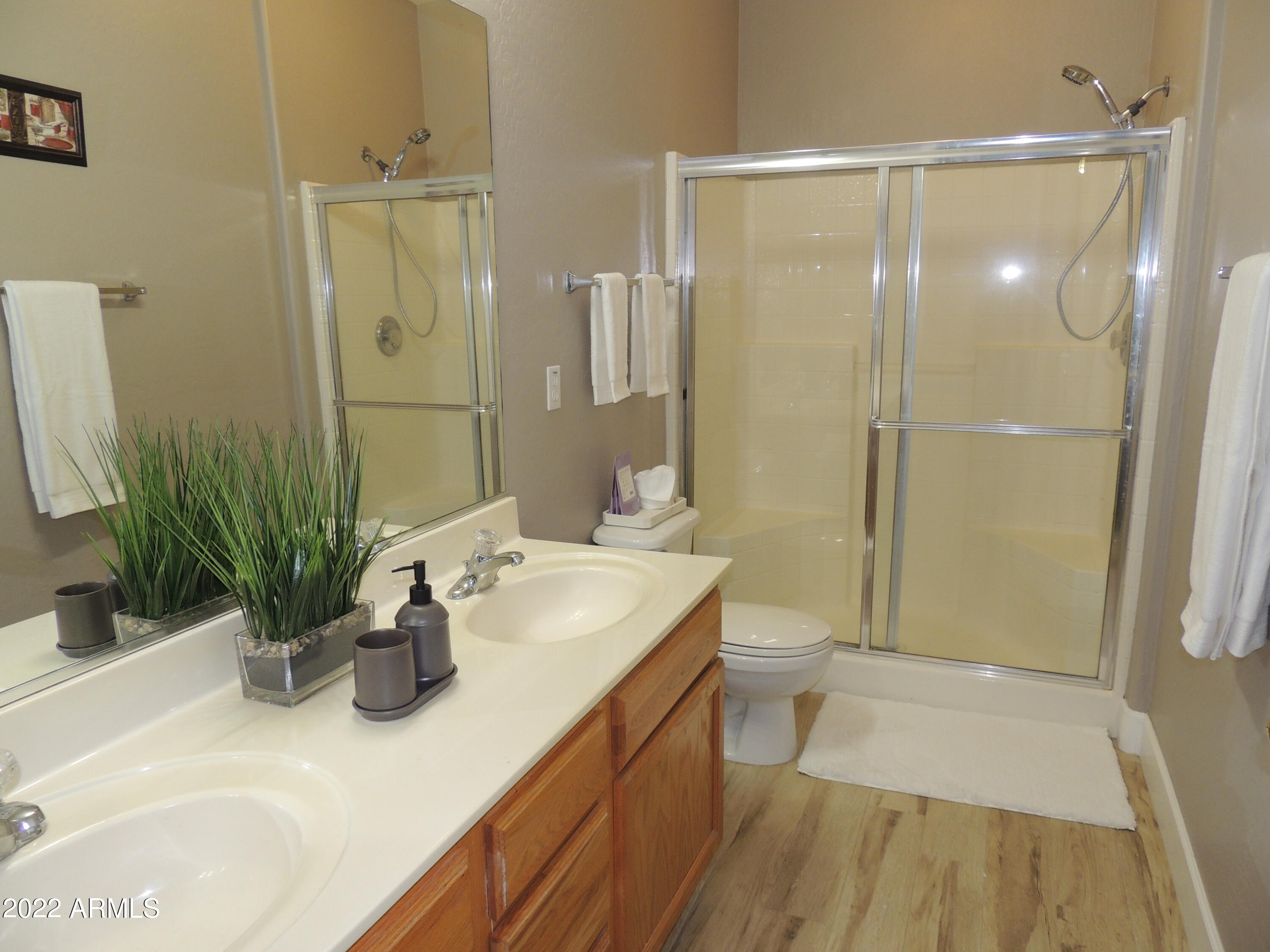 525 North Miller Road, Unit 129 Scottsdale, AZ 85257 - Photo 13 of 19 a bathroom with a sink a toilet and shower