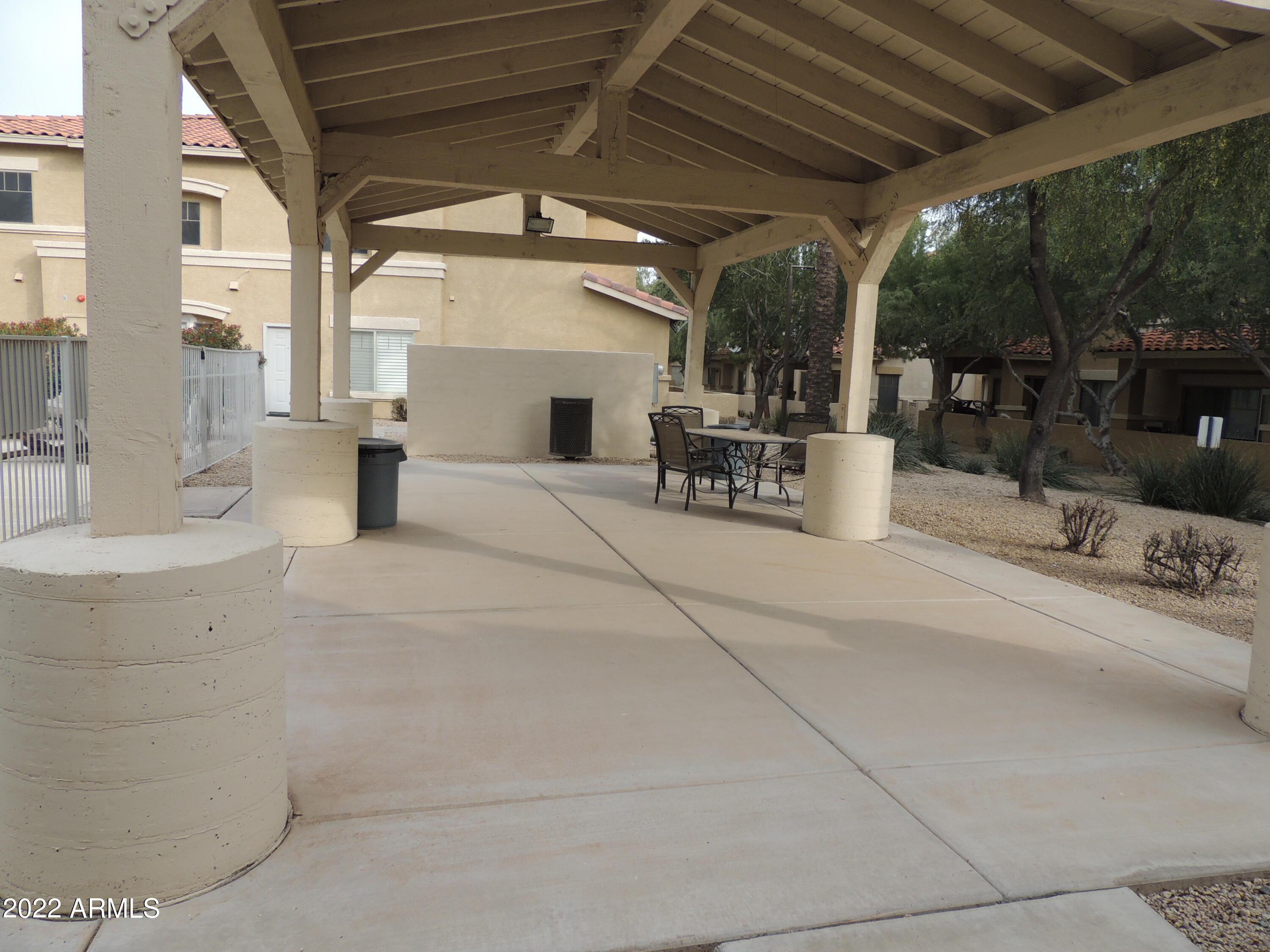 525 North Miller Road, Unit 129 Scottsdale, AZ 85257 - Photo 18 of 19 a view of a patio with table and chairs and potted plants
