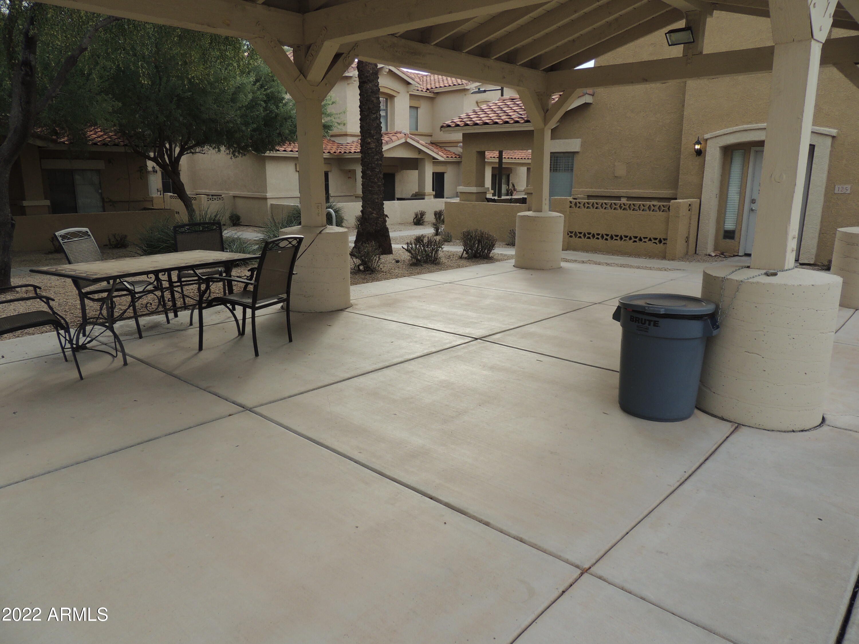 525 North Miller Road, Unit 129 Scottsdale, AZ 85257 - Photo 19 of 19 a view of a patio with table and chairs a barbeque