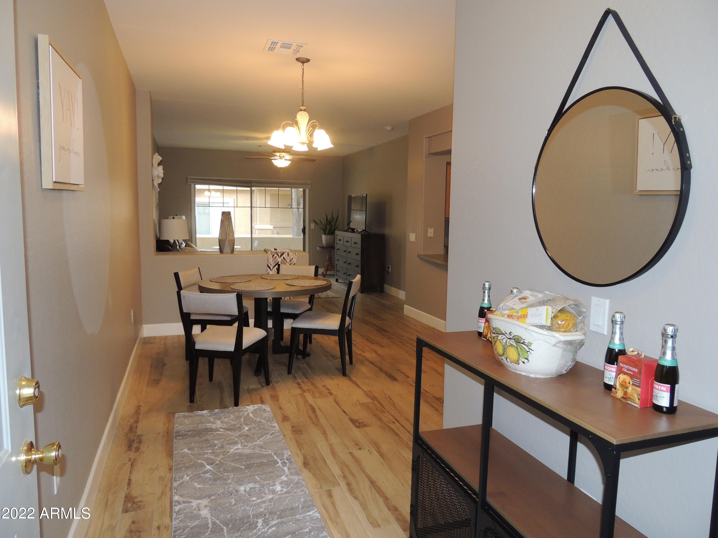 525 North Miller Road, Unit 129 Scottsdale, AZ 85257 - Photo 2 of 19 a dining room with furniture a rug and a mirror