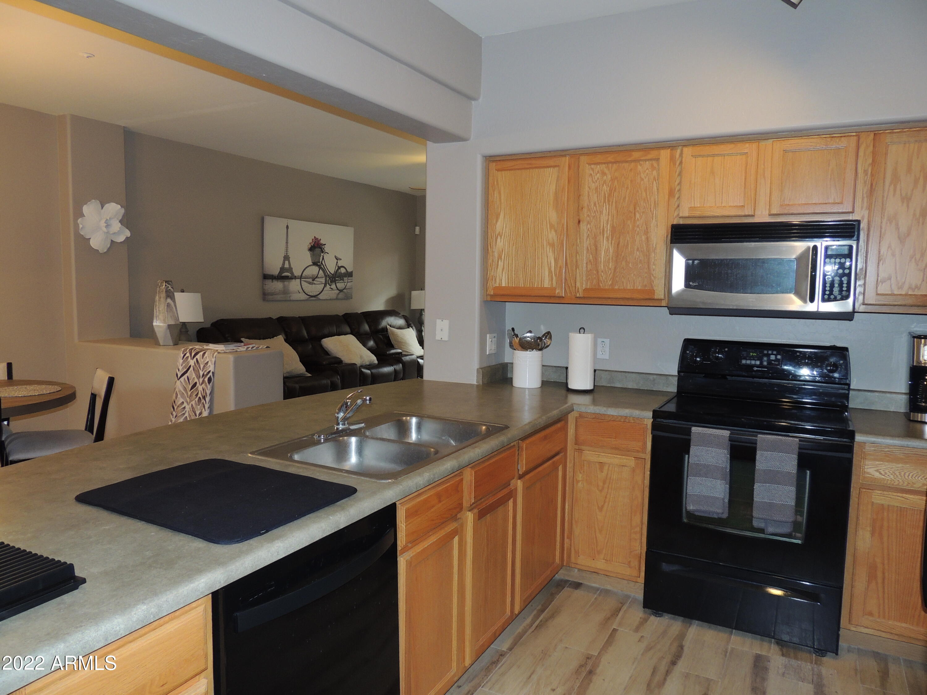 525 North Miller Road, Unit 129 Scottsdale, AZ 85257 - Photo 6 of 19 a kitchen with a sink stove and microwave