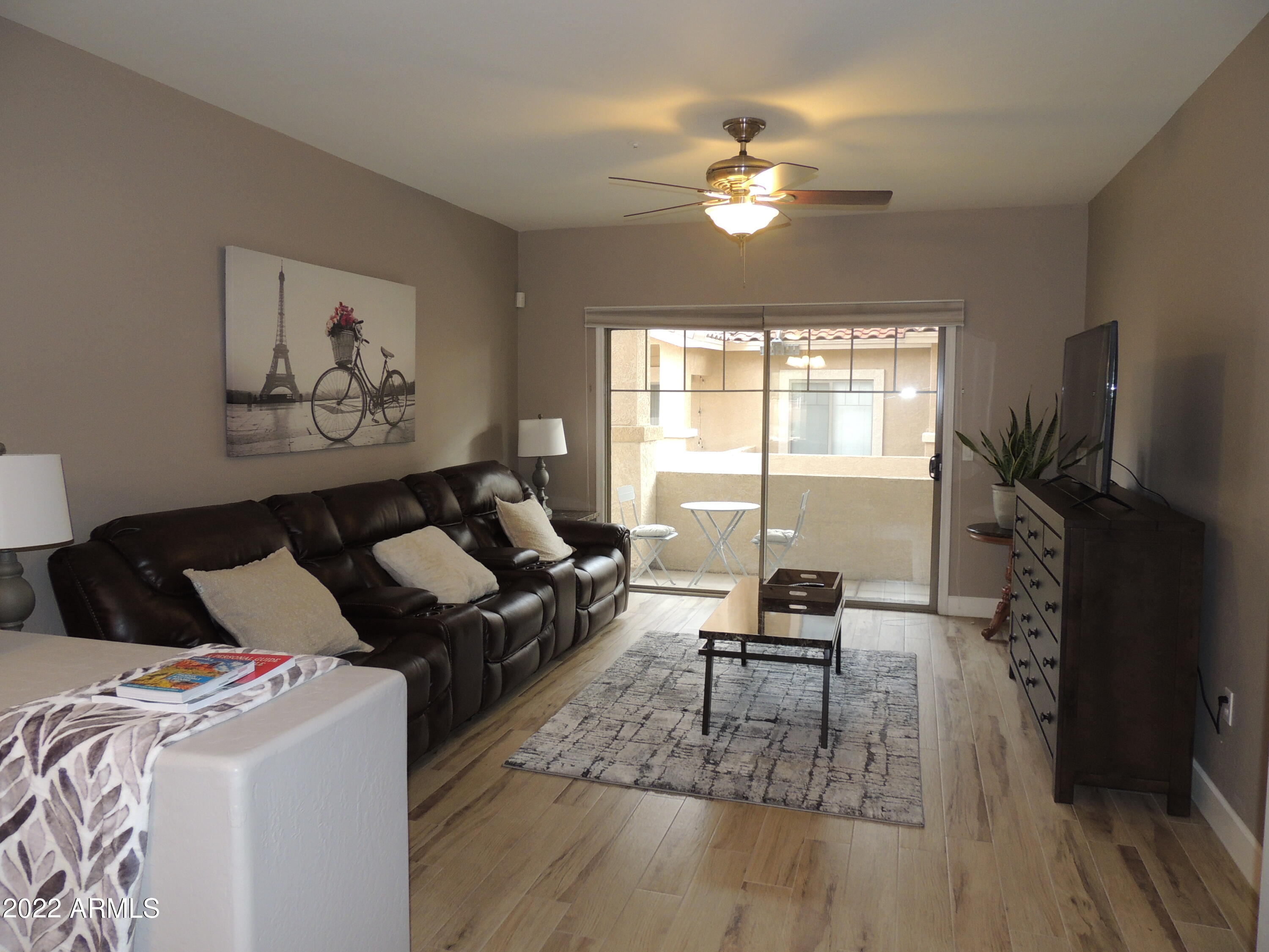 525 North Miller Road, Unit 129 Scottsdale, AZ 85257 - Photo 8 of 19 a living room with furniture and a chandelier