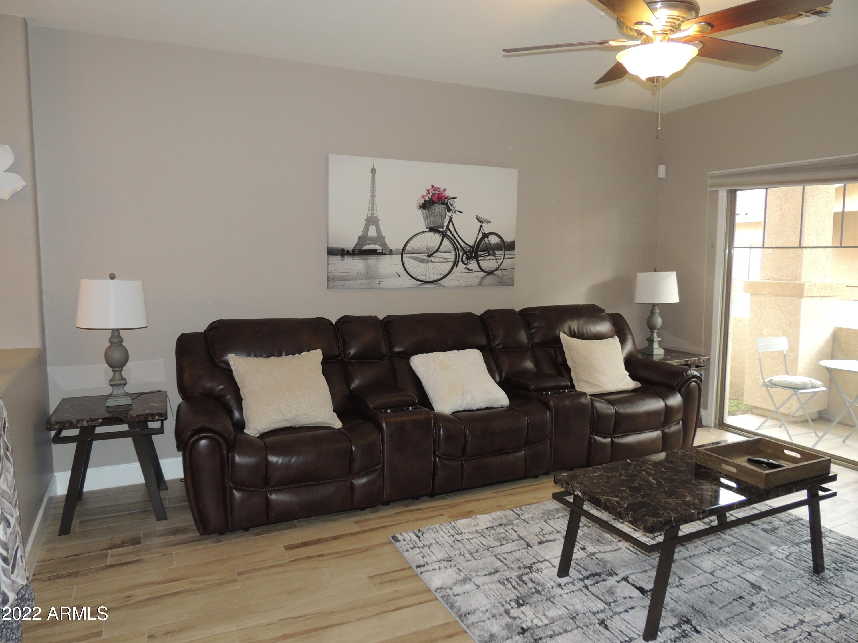 525 North Miller Road, Unit 129 Scottsdale, AZ 85257 - Photo 9 of 19 a living room with furniture and wooden floor