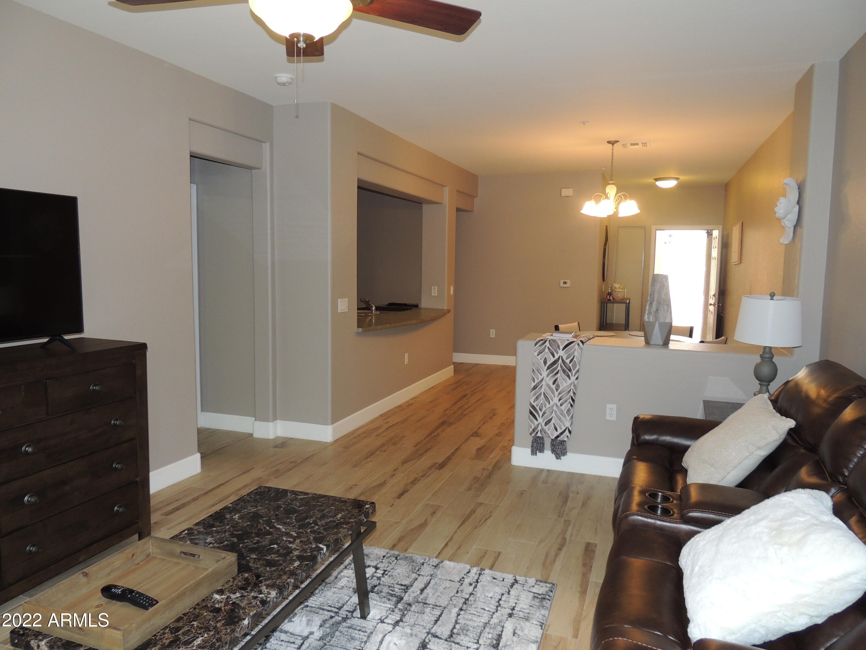525 North Miller Road, Unit 129 Scottsdale, AZ 85257 - Photo 10 of 19 a living room with furniture and a flat screen tv