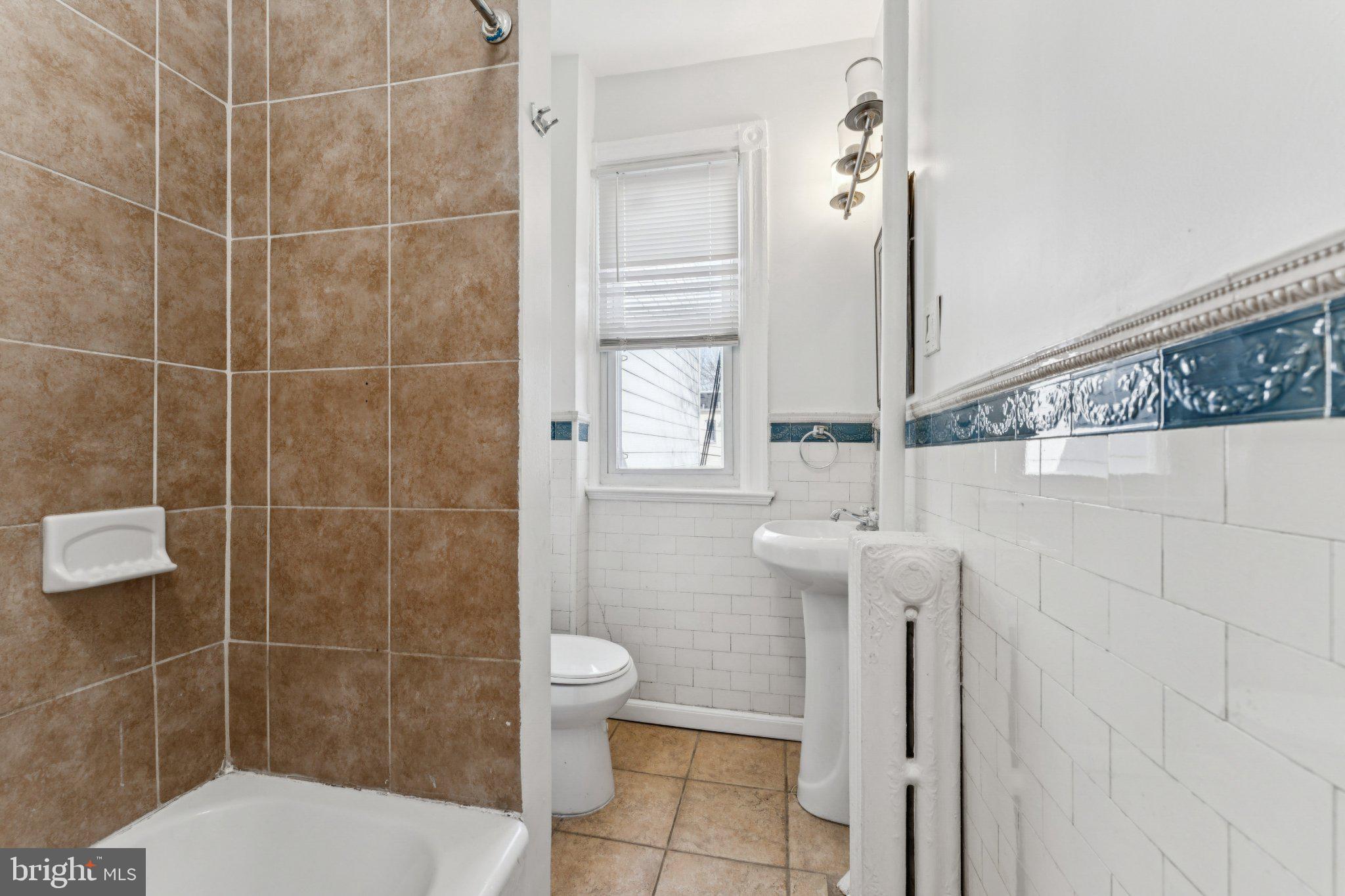 621 Kenyon Street Northwest Washington, DC 20010 - Photo 13 of 25 a bathroom with a toilet sink and shower