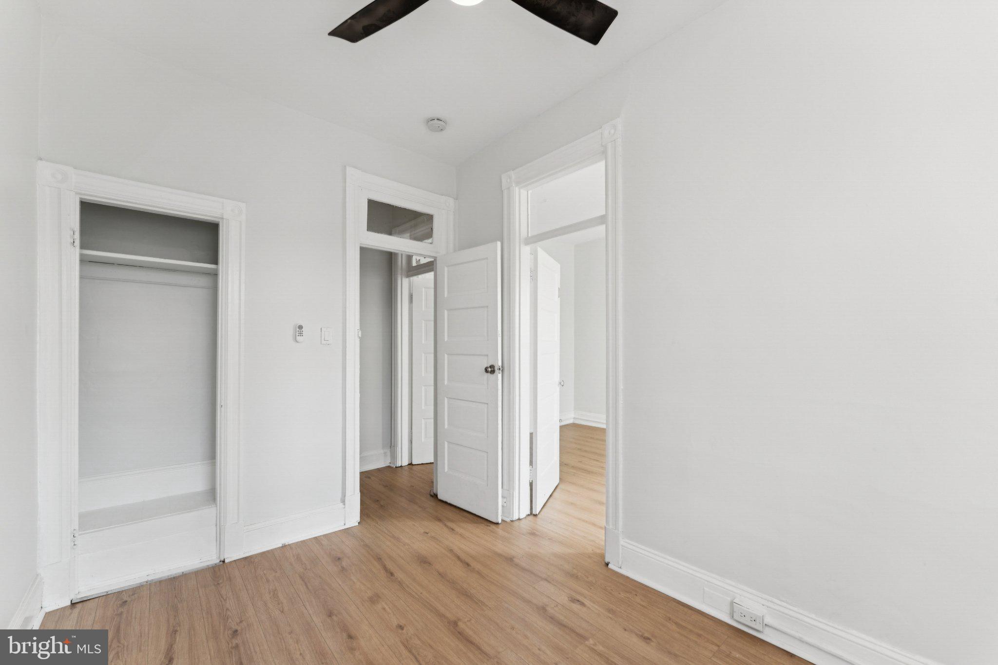 621 Kenyon Street Northwest Washington, DC 20010 - Photo 17 of 25 an empty room with wooden floor and windows