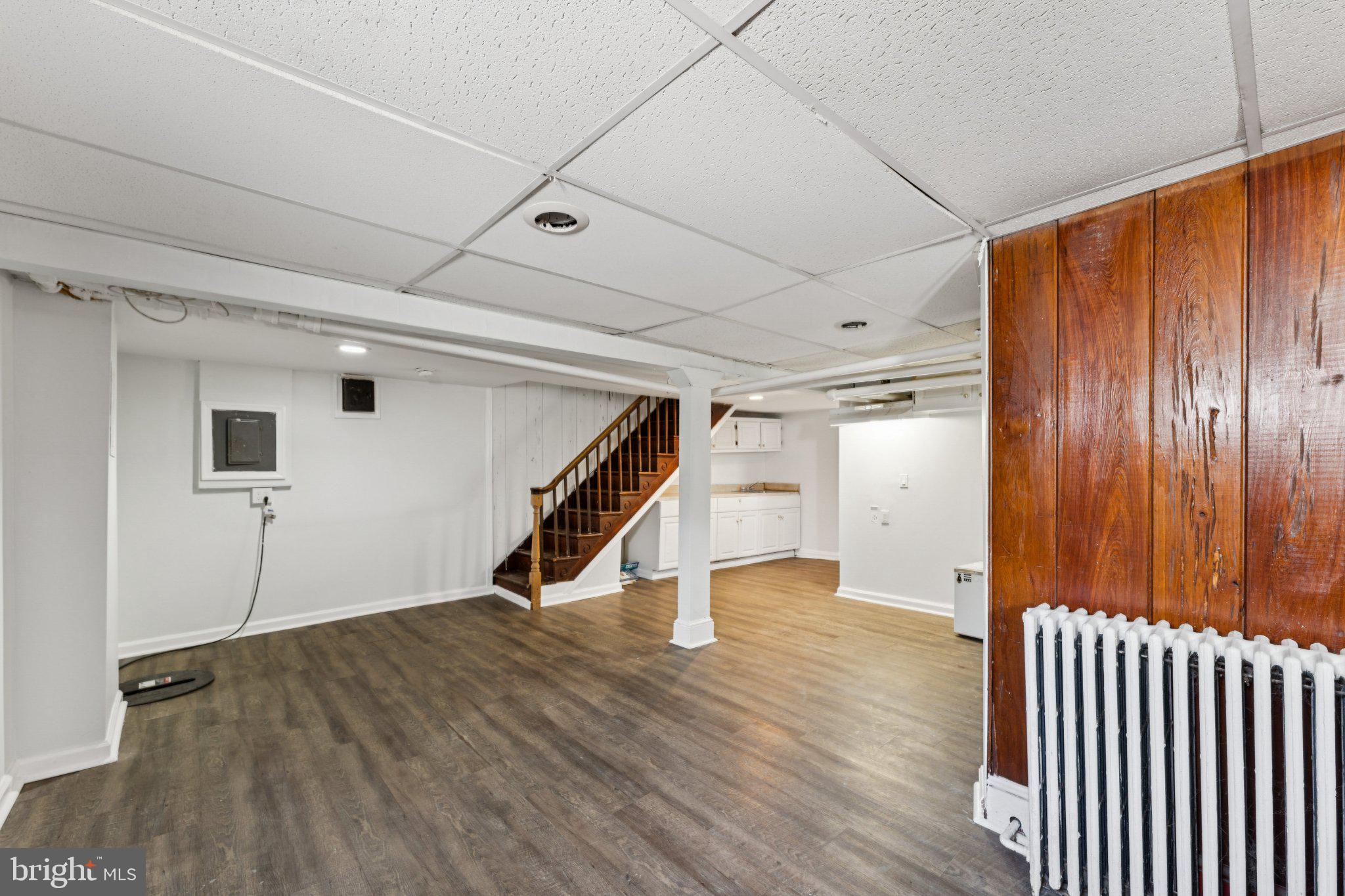 621 Kenyon Street Northwest Washington, DC 20010 - Photo 20 of 25 a view of an empty room with stairs and wooden floor