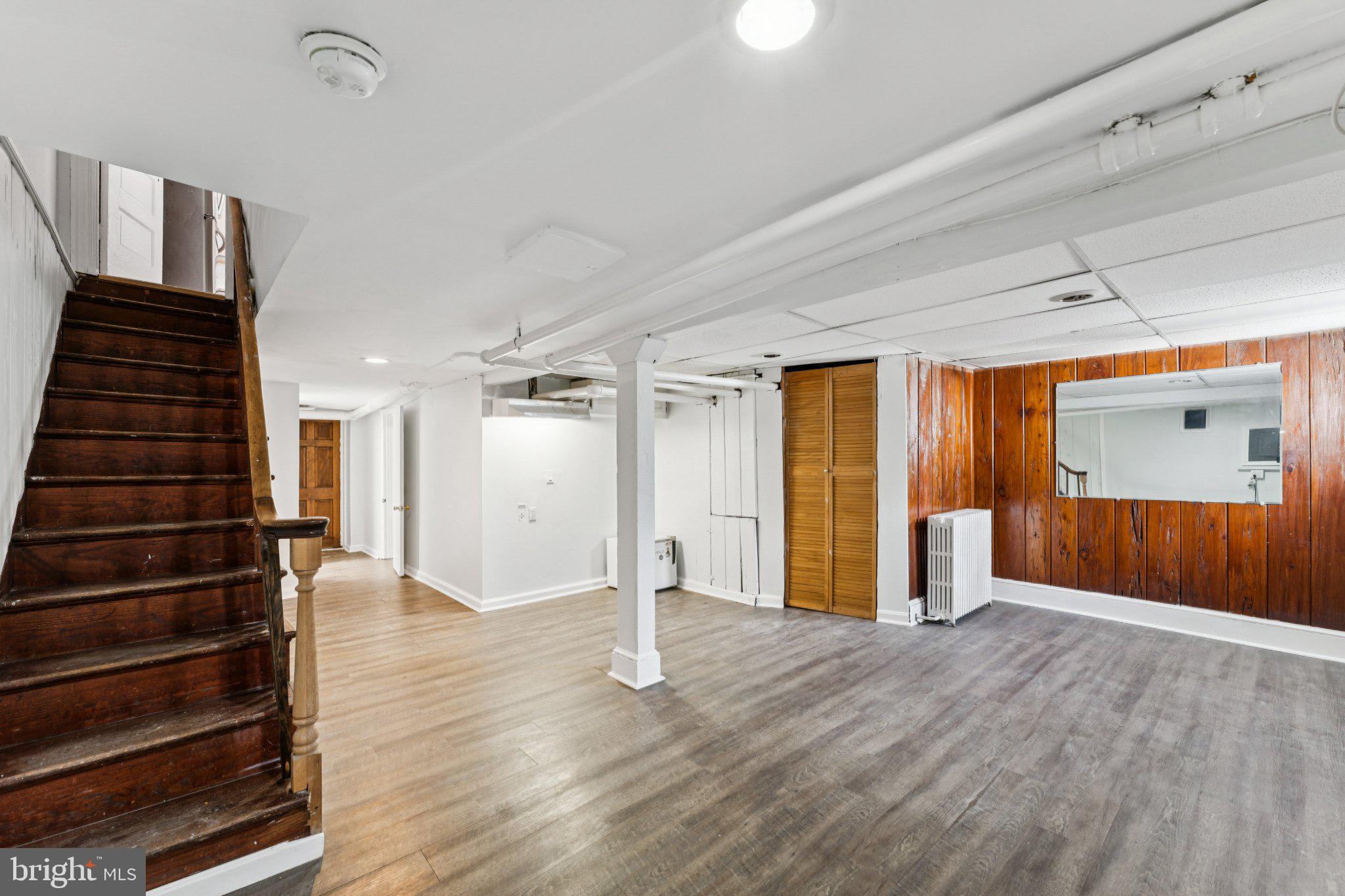 621 Kenyon Street Northwest Washington, DC 20010 - Photo 21 of 25 a view of an empty room with wooden floor and stairs