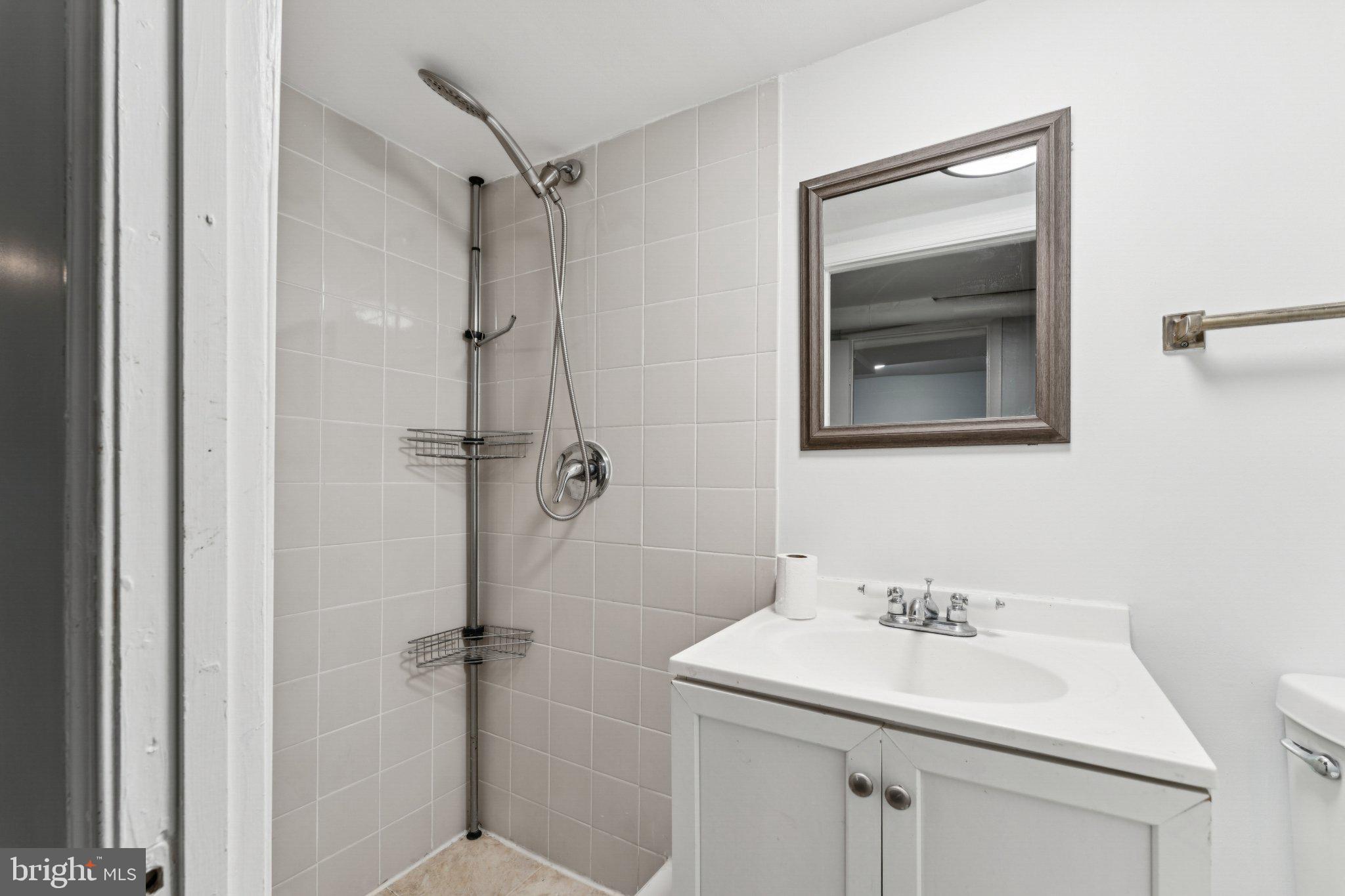 621 Kenyon Street Northwest Washington, DC 20010 - Photo 23 of 25 a bathroom with a sink toilet and shower