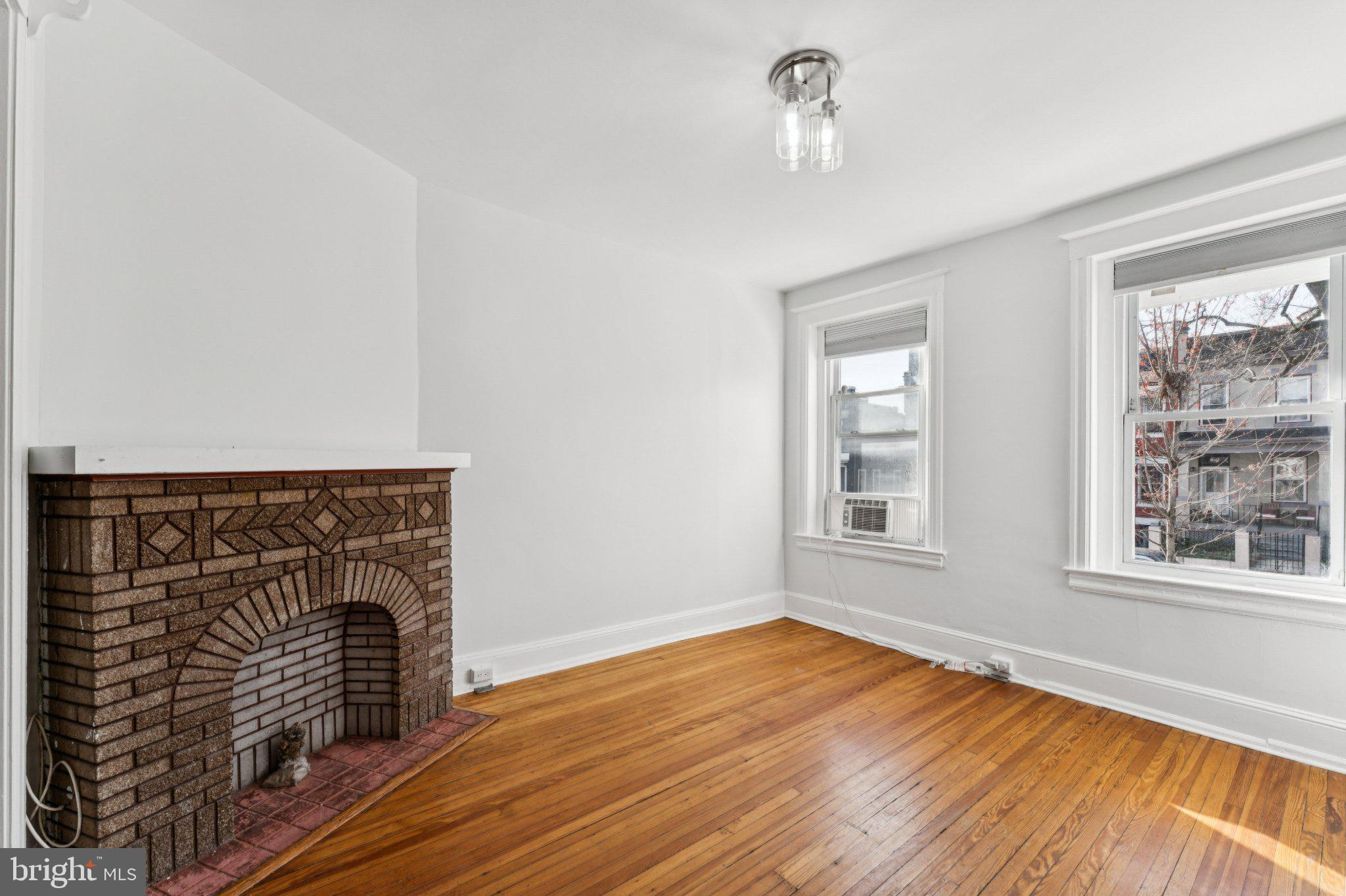 621 Kenyon Street Northwest Washington, DC 20010 - Photo 5 of 25 a view of empty room with wooden floor and fan