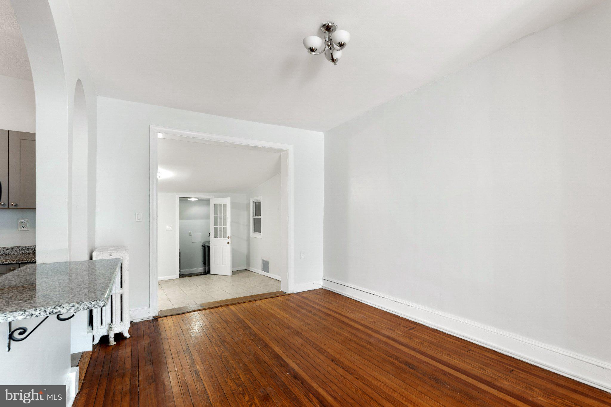 621 Kenyon Street Northwest Washington, DC 20010 - Photo 7 of 25 a view of a room with wooden floor and cabinet