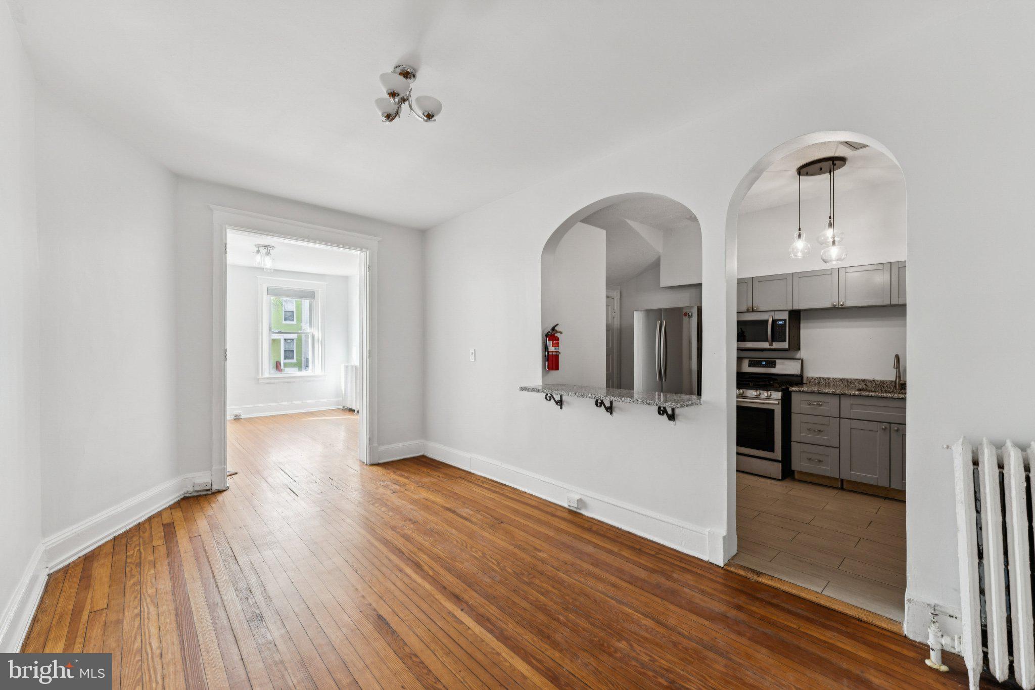 621 Kenyon Street Northwest Washington, DC 20010 - Photo 8 of 25 a view of a kitchen with wooden floor and electronic appliances