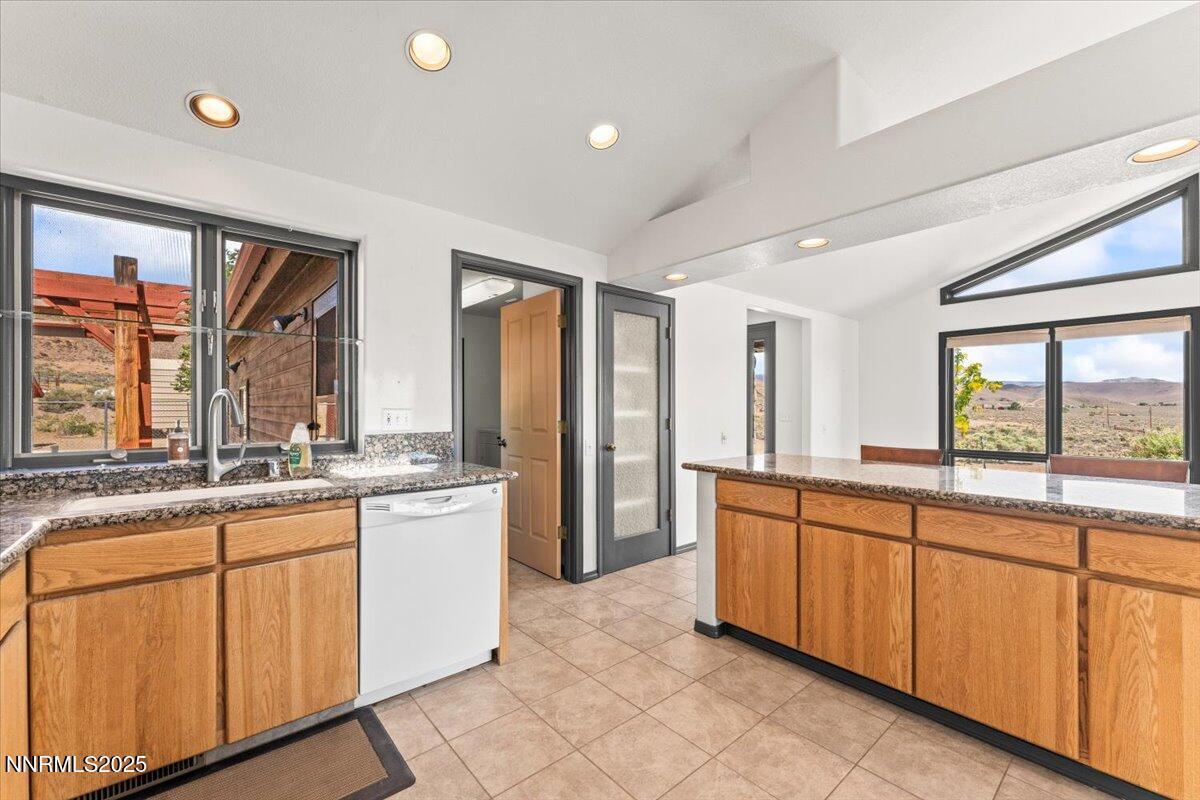 5455 Wild Horse Road Reno, NV 89510 - Photo 14 of 33 a large kitchen with kitchen island granite countertop a large window and a sink