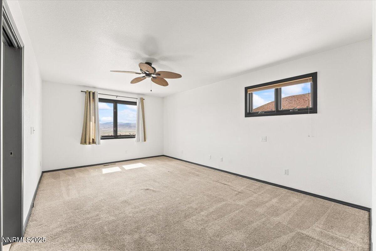 5455 Wild Horse Road Reno, NV 89510 - Photo 17 of 33 an empty room with windows and ceiling fan