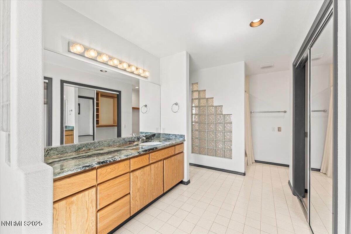 5455 Wild Horse Road Reno, NV 89510 - Photo 20 of 33 a spacious bathroom with a granite countertop sink a mirror and a shower