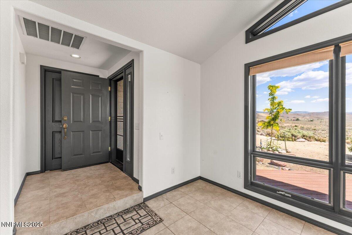 5455 Wild Horse Road Reno, NV 89510 - Photo 6 of 33 a view of hallway with a large window and chandelier