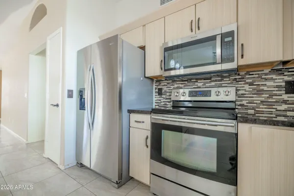 a kitchen with stainless steel appliances wooden cabinets and a stove top oven