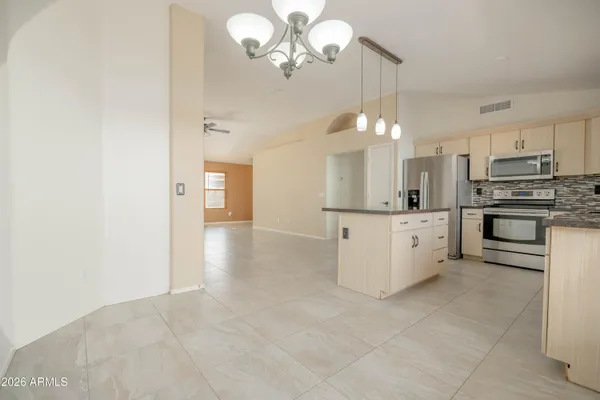 a view of a room with wooden floor and a ceiling fan