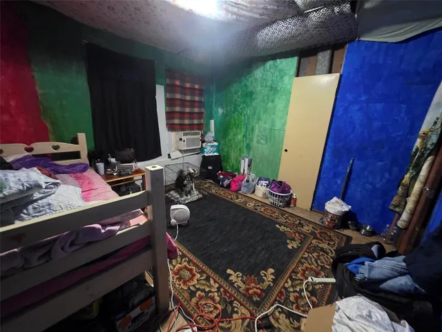 a bedroom with a bed and a television