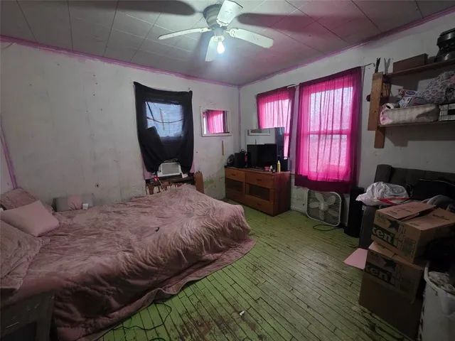 a bed room with furniture and a flat screen tv