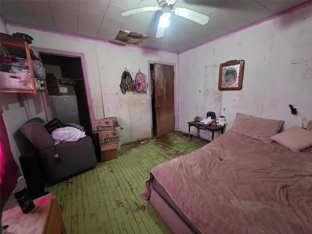 a bedroom with furniture and a flat screen tv