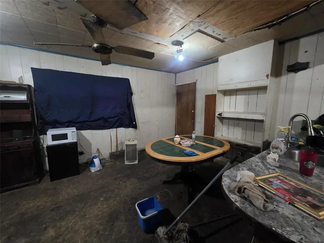 a kitchen with a table and chairs in it