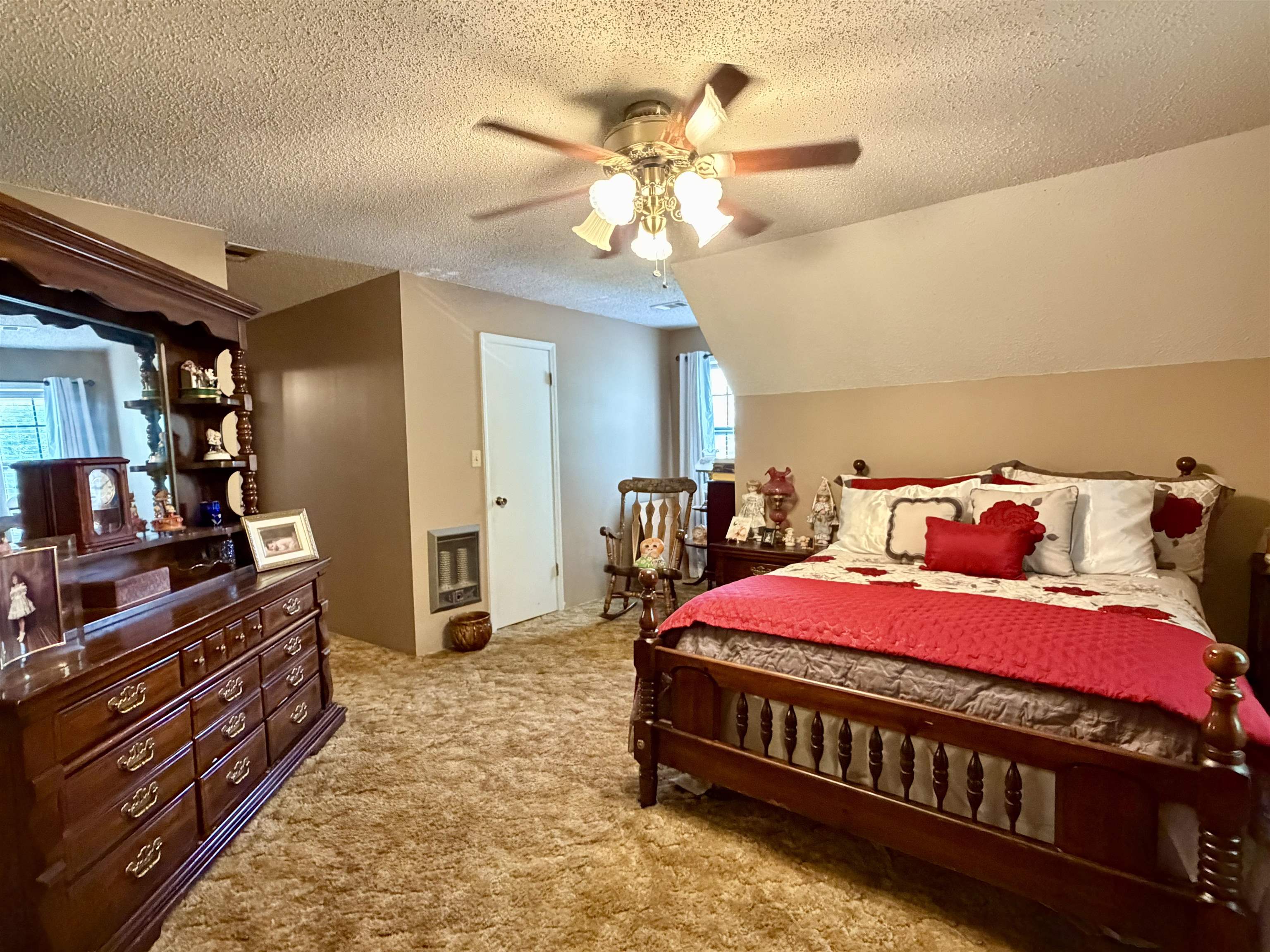 142 Treece Street Selmer, TN 38375 - Photo 21 of 36 Carpeted room featuring a ceiling fan with integrated lighting, a sloped ceiling, and an interior door