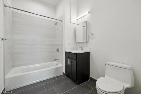 a bathroom with a toilet bathtub and shower