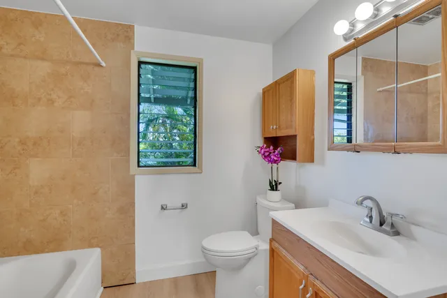 a bathroom with a sink toilet and mirror