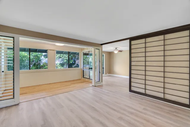 a view of a room with window and hardwood floor