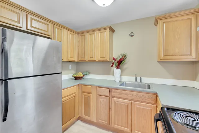 a white refrigerator freezer sitting in a kitchen