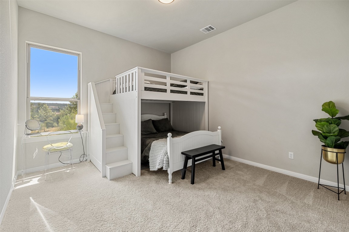 2220 Normandy View Leander, TX 78641 - Photo 37 of 40 Bedroom featuring light colored carpet and baseboards