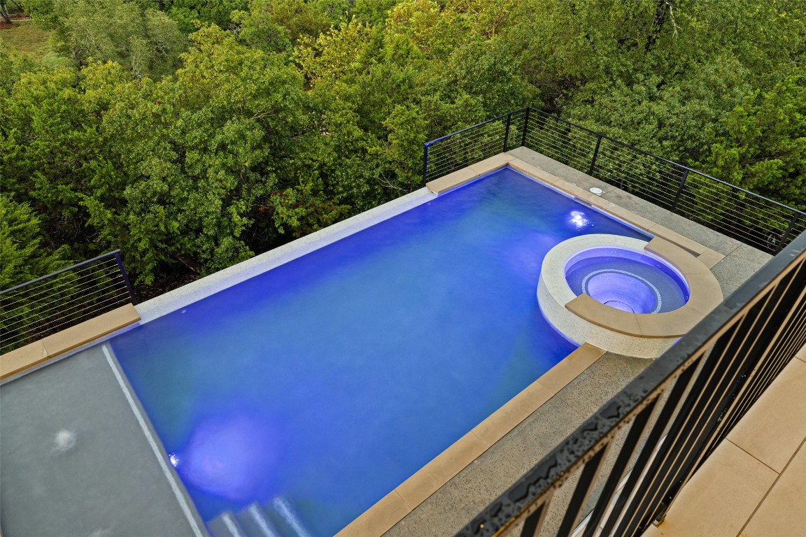 2220 Normandy View Leander, TX 78641 - Photo 4 of 40 View of pool with a pool with connected hot tub and a wooded view