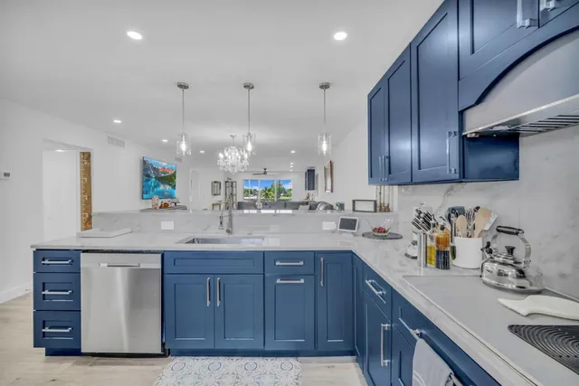 a kitchen with a sink a cabinets and wooden floor